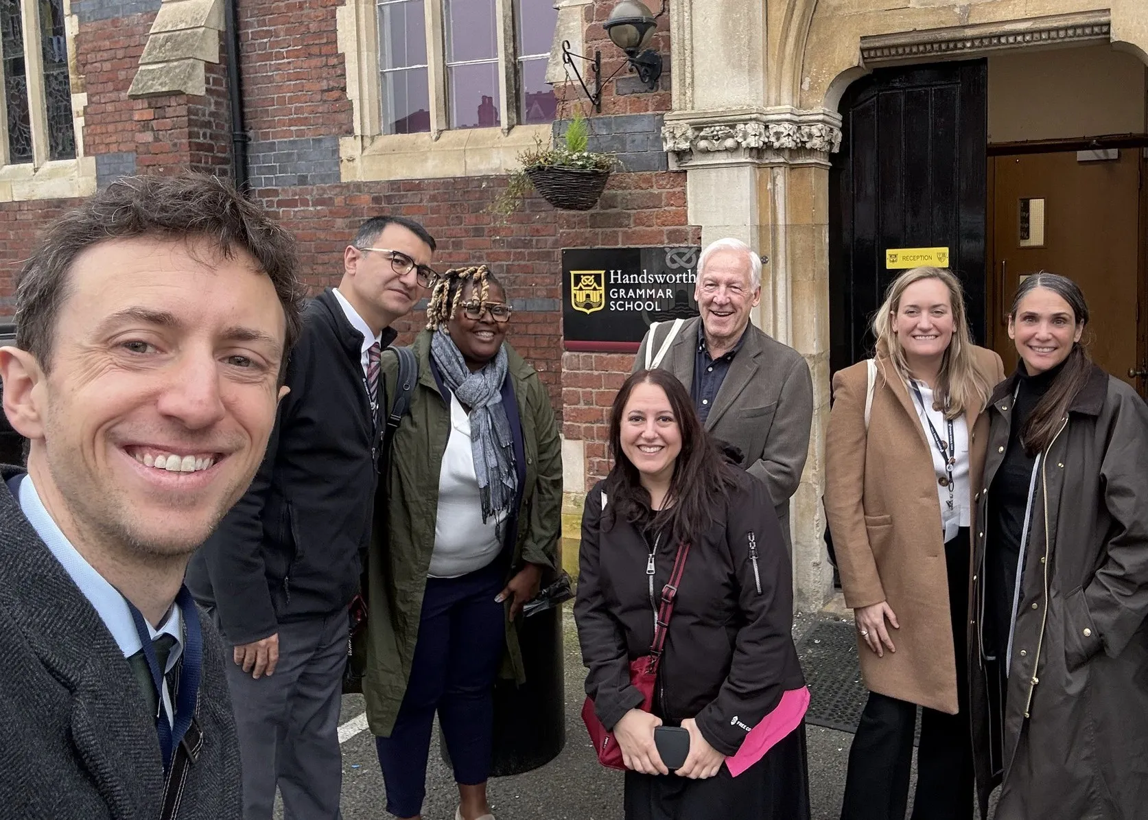Group of administrators standing outside a school in the United Kingdom