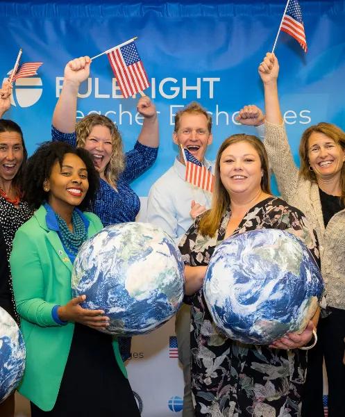 a group of people holding flags and globes
