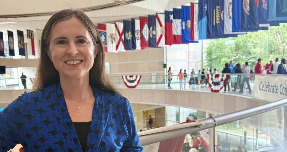 a woman posing in front of U.S. state flags